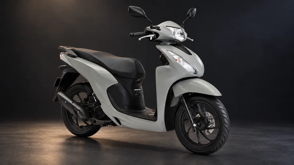Cinematic studio view of a light grey scooter